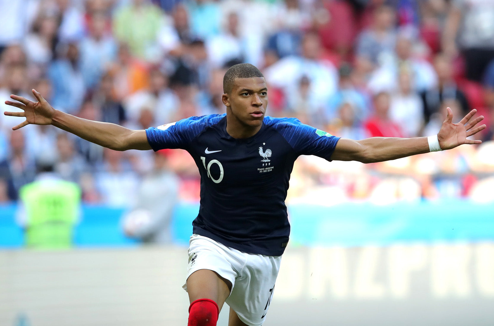  Kylian Mbappe, a French soccer player, is in action on the field during a match.